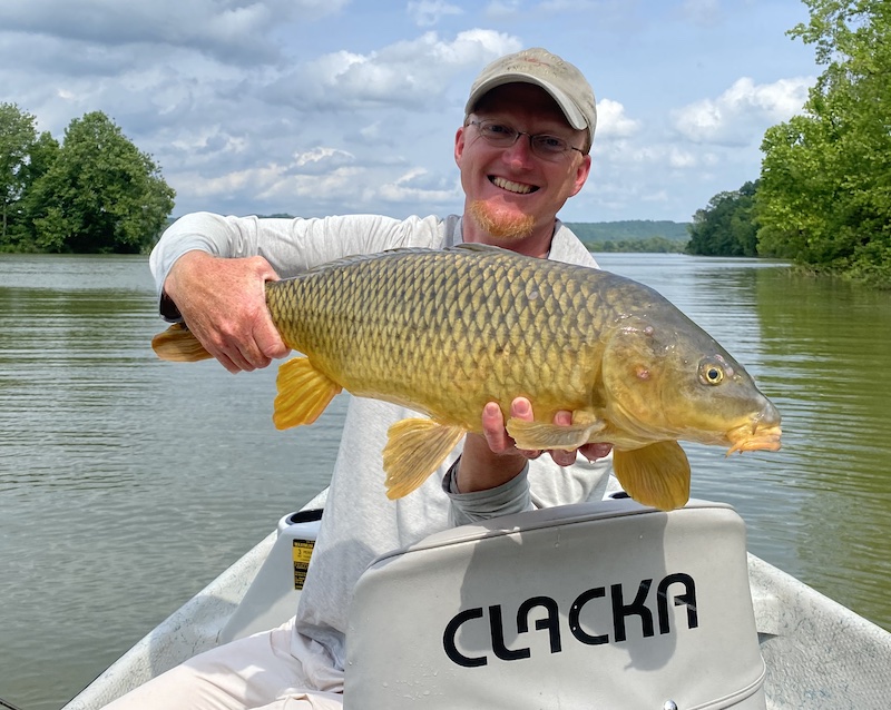 Trout Zone Anglers owner and head guide David Knapp hoists a large common carp caught during the Brood XIV emergence. Period cicada fly fishing is one of David's favorite things to do.